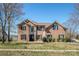 Charming brick two-story home featuring a well-manicured lawn and black shutters at 5000 Tulip Ln, Matthews, NC 28104