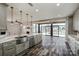 Open-concept kitchen featuring quartz countertops, stainless steel appliances and hardwood floors at 5000 Tulip Ln, Matthews, NC 28104