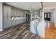 Spacious kitchen features gray cabinets, a marble backsplash, quartz countertops, and wood-look flooring at 5000 Tulip Ln, Matthews, NC 28104