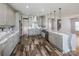 Large kitchen with gray cabinets, a kitchen island and wood look floors with quartz countertops at 5000 Tulip Ln, Matthews, NC 28104