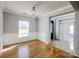 Light-filled living room with hardwood floors, elegant wainscoting, modern trim, and a stylish chandelier at 5000 Tulip Ln, Matthews, NC 28104