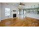 Living room with a fireplace and access to a sunroom and kitchen through sliding doors at 5000 Tulip Ln, Matthews, NC 28104