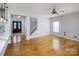 Open living room with hardwood floors, grey walls, and staircase access to the upper floor at 5000 Tulip Ln, Matthews, NC 28104
