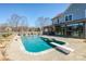 Backyard featuring a private pool, tanning ledge, lounge chairs, and patio area at 5000 Tulip Ln, Matthews, NC 28104