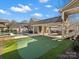 Backyard putting green, pool, and covered patio for outdoor entertaining at 519 Fourth Baxter Xing, Fort Mill, SC 29708