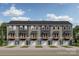 View of new townhome exteriors featuring modern design with attached single car garages and small front yards at 550 Beatties Ford Rd, Charlotte, NC 28216