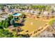 An aerial view showcasing the neighborhood's pond with fountain and community pool area at 565 Sugar Tree Dr, Rock Hill, SC 29732
