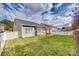 A spacious backyard featuring a well-maintained lawn and a white picket fence under a cloudy sky at 565 Sugar Tree Dr, Rock Hill, SC 29732
