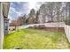 An expansive backyard with lush green grass, defined by a tall white fence and mature trees at 565 Sugar Tree Dr, Rock Hill, SC 29732
