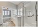 Bathroom featuring a glass-enclosed shower and soaking tub in a bright, tiled space at 565 Sugar Tree Dr, Rock Hill, SC 29732