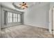 Spacious primary bedroom with a ceiling fan and large windows with decorative shutters at 565 Sugar Tree Dr, Rock Hill, SC 29732