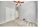 Bright bedroom featuring neutral walls, carpet, closet, and ceiling fan with overhead light at 565 Sugar Tree Dr, Rock Hill, SC 29732