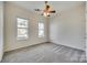 Comfortable bedroom with neutral walls, ceiling fan, and natural light from dual windows at 565 Sugar Tree Dr, Rock Hill, SC 29732