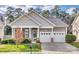 Charming single-story home with a two-car garage, well-manicured lawn, and inviting front porch at 565 Sugar Tree Dr, Rock Hill, SC 29732