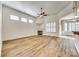 Spacious living room with a fireplace, large windows, and modern ceiling fan at 565 Sugar Tree Dr, Rock Hill, SC 29732
