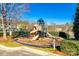A well-maintained playground area featuring a variety of equipment in a landscaped setting at 565 Sugar Tree Dr, Rock Hill, SC 29732