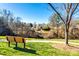 Scenic pond view featuring a fountain, walking trail and park bench in a quiet community at 565 Sugar Tree Dr, Rock Hill, SC 29732