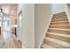 Carpeted staircase leading to the upper level of the home, adjacent to vinyl flooring at 565 Sugar Tree Dr, Rock Hill, SC 29732