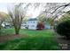Spacious backyard featuring a well-maintained lawn and a charming pergola at 5925 Carmel Station Ave, Charlotte, NC 28226