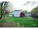 Lush backyard featuring a manicured lawn, mature landscaping, and an elegant pergola at 5925 Carmel Station Ave, Charlotte, NC 28226