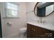Bathroom features a wooden vanity with marble countertop and updated faucet at 5925 Carmel Station Ave, Charlotte, NC 28226