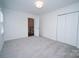 Bright bedroom featuring neutral walls, plush carpeting, and closet at 5925 Carmel Station Ave, Charlotte, NC 28226