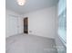 Bright bedroom featuring neutral walls, plush carpeting, and windows providing natural light at 5925 Carmel Station Ave, Charlotte, NC 28226