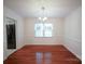 Classic dining room with hardwood floors, chandelier, and natural light at 5925 Carmel Station Ave, Charlotte, NC 28226