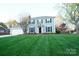 Charming two-story home with a well-manicured lawn, attached garage, and inviting front entrance at 5925 Carmel Station Ave, Charlotte, NC 28226