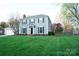 Charming two-story home with blue siding, black shutters, and lush green lawn at 5925 Carmel Station Ave, Charlotte, NC 28226