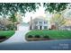Beautiful two-story home featuring an attached garage and a manicured front lawn at 5925 Carmel Station Ave, Charlotte, NC 28226