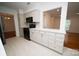 Open kitchen with white cabinets, countertops, and modern black appliances at 5925 Carmel Station Ave, Charlotte, NC 28226