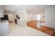 Modern kitchen with white cabinets, stainless steel appliances, and an open layout to the living area at 5925 Carmel Station Ave, Charlotte, NC 28226