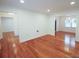 Spacious living room with hardwood floors, bright lighting, and neutral walls at 5925 Carmel Station Ave, Charlotte, NC 28226