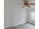 A clean bedroom with a ceiling fan, wood-look vinyl floors and natural light at 609 Cedar St, Wadesboro, NC 28170