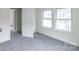Bedroom featuring windows letting in natural light, neutral carpeting and an open doorway at 609 Cedar St, Wadesboro, NC 28170