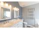 Bathroom with dual vanity sinks and illuminated vanity lighting at 7001 Conifer Cir, Indian Trail, NC 28079
