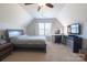 Spacious bedroom with sloped ceilings and a comfortable workstation at 7001 Conifer Cir, Indian Trail, NC 28079