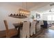 Elegant dining room with modern lighting and a view into the living room, perfect for entertaining at 7001 Conifer Cir, Indian Trail, NC 28079