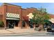A single story commercial brick building with awnings for sale in a business park at 7001 Conifer Cir, Indian Trail, NC 28079