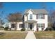 Charming two-story home featuring a welcoming front porch and landscaped yard at 7001 Conifer Cir, Indian Trail, NC 28079