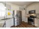 Updated kitchen features stainless steel appliances, granite countertops, and white cabinets at 7001 Conifer Cir, Indian Trail, NC 28079