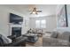 Bright living room featuring a fireplace, ceiling fan, and comfortable seating arrangement at 7001 Conifer Cir, Indian Trail, NC 28079