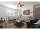 Cozy living room showcasing natural light, modern decor, and a stylish area rug at 7001 Conifer Cir, Indian Trail, NC 28079