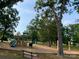 A playground with slides, swings, benches and a wood chip safety surface at 7001 Conifer Cir, Indian Trail, NC 28079