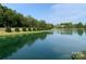 Scenic water view with lush greenery and manicured bushes under a clear blue sky at 7001 Conifer Cir, Indian Trail, NC 28079