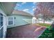 The backyard has a brick patio and green grass, offering a perfect spot for outdoor entertainment and relaxation at 7037 Ladys Secret Dr, Indian Trail, NC 28079