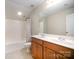 The bathroom features double sinks, a large mirror, and a shower-tub combination at 7037 Ladys Secret Dr, Indian Trail, NC 28079