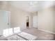 This bedroom features neutral walls, a ceiling fan, and carpeted floors, creating a serene and inviting space at 7037 Ladys Secret Dr, Indian Trail, NC 28079
