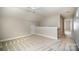 This bonus room offers a cozy atmosphere with its vaulted ceilings and plush carpeting at 7037 Ladys Secret Dr, Indian Trail, NC 28079